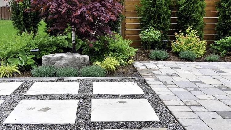 Garden path with permeable pavers, gravel, and assorted native plants