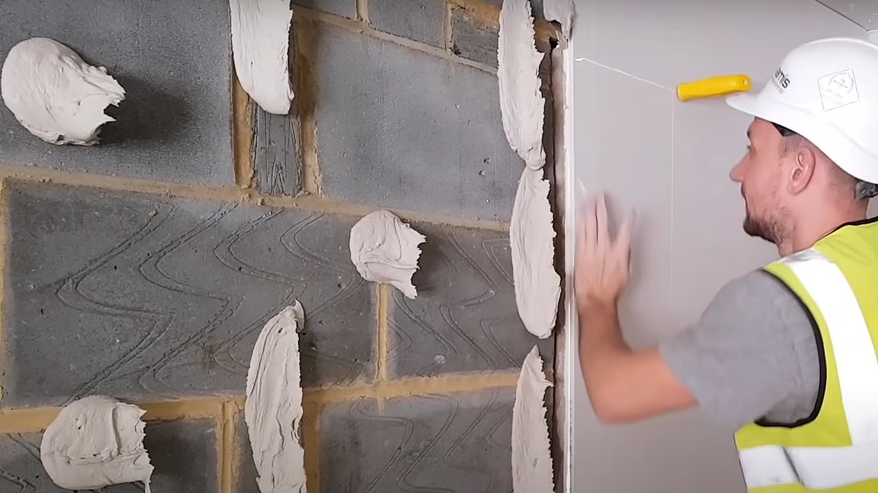 Worker Installing Plasterboard Using the Dot and Dab Method