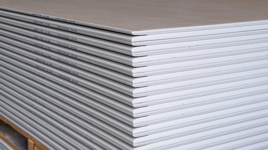 Stack of standard drywall plasterboards ready for installation