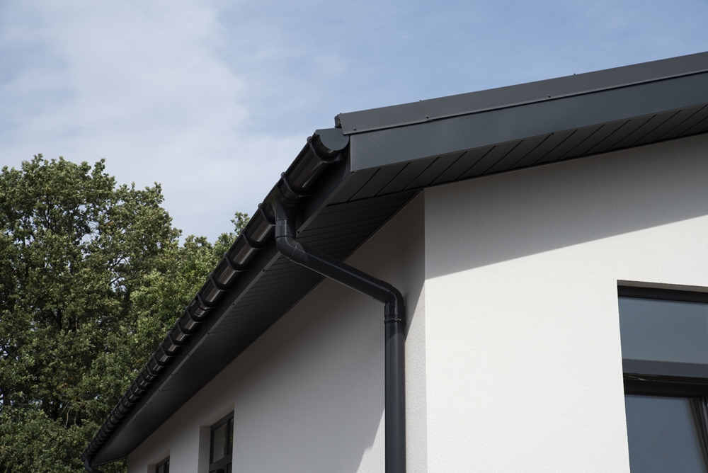 uPVC roofline with black guttering and fascia installed on modern house exterior