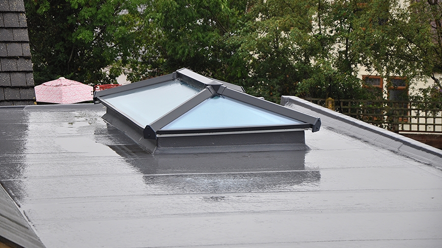 Flat roof with liquid-applied membrane and skylight, showcasing a seamless waterproof finish.