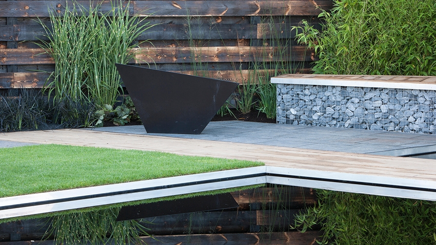 Modern reflective pond with a landscaped garden